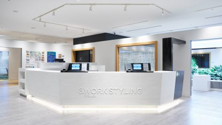 東京都千代田区大手町・東京駅徒歩14分、神田駅徒歩12分、Otemachi Oneタワー6階に拠点を構える、テレワークや出張時の業務に対応する法人向けシェアオフィス／コワーキングスペース「ワークスタイリング大手町」の受付エントランス。大手町駅直結という抜群のアクセスを誇り、白基調のモダンで洗練された空間に、セルフチェックイン端末を備えた受付カウンターを設置。周辺には大手町ビルや大手町ファーストスクエア、大手町サンケイビル、日本生命丸の内ガーデンタワーなどが集積し、リージャスやサーブコープ、ビジネス・エアポートといったワークスペースも展開する屈指のビジネスエリアに位置する拠点